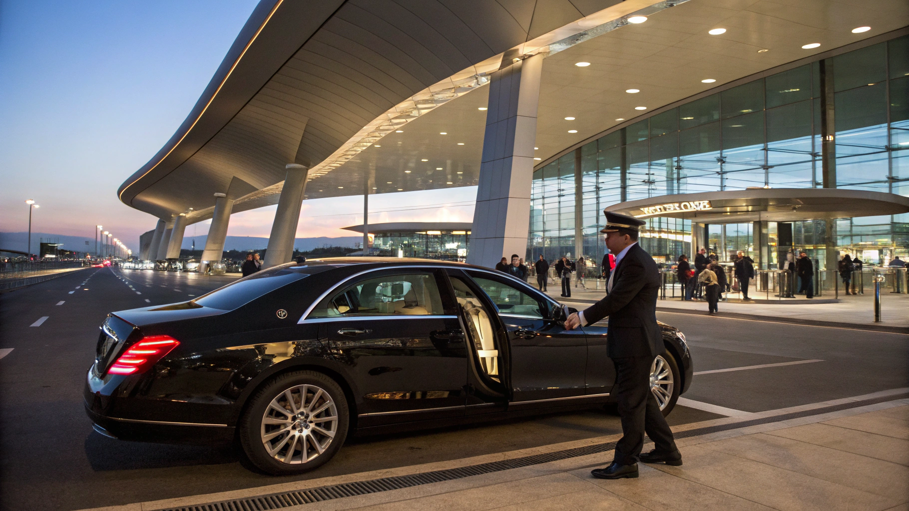 Luxury black SUV staged outside LAX Bradley terminal under dusk overhead lights